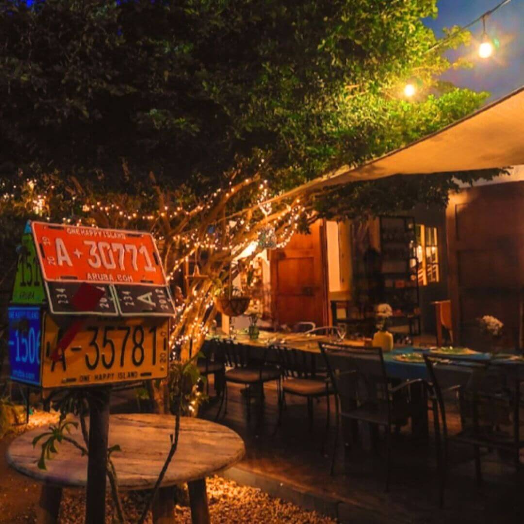 Intimate small group dinner with strangers tablescape setup outside at night with fairy lights